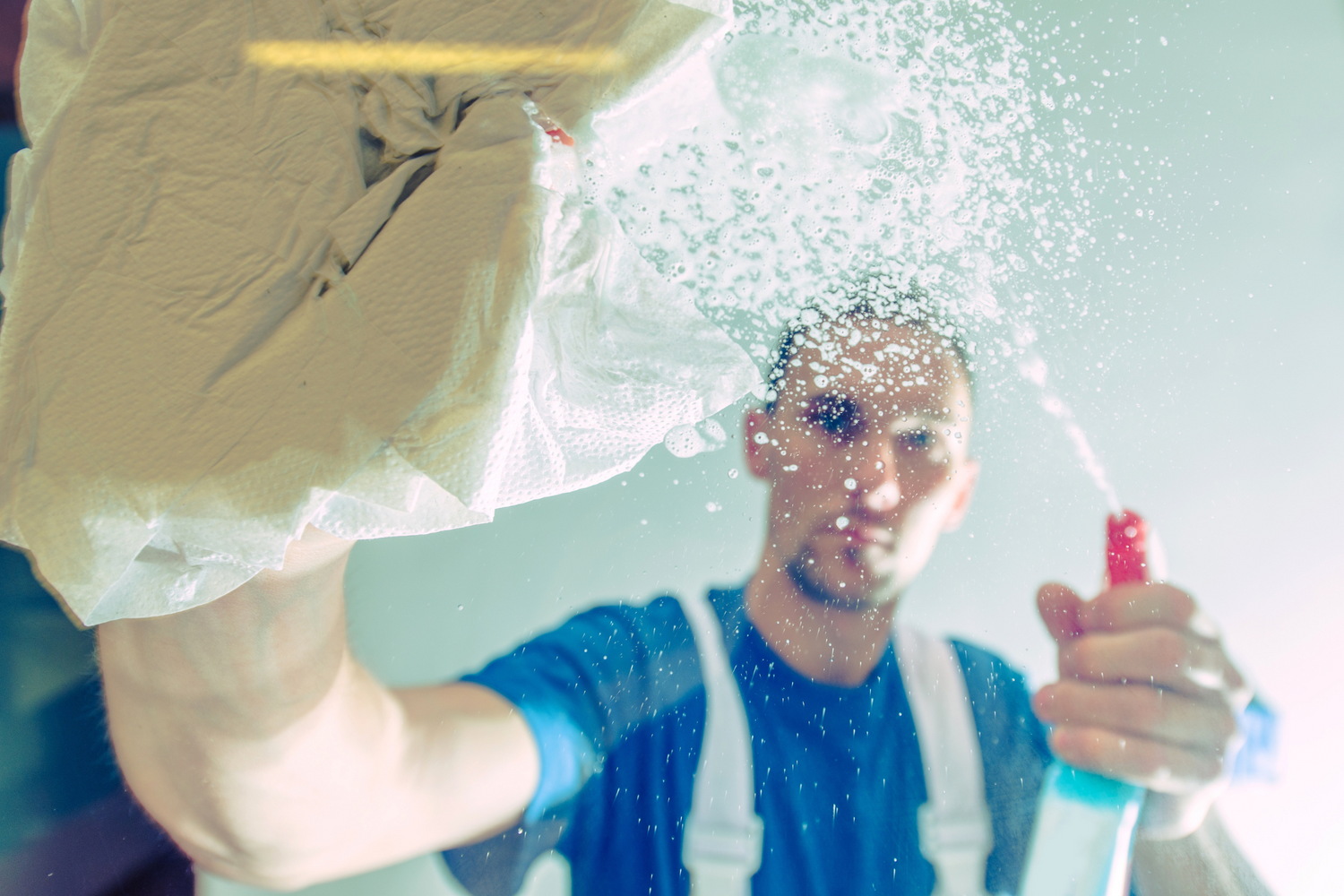 Image of a Cleaning tech cleaning a window